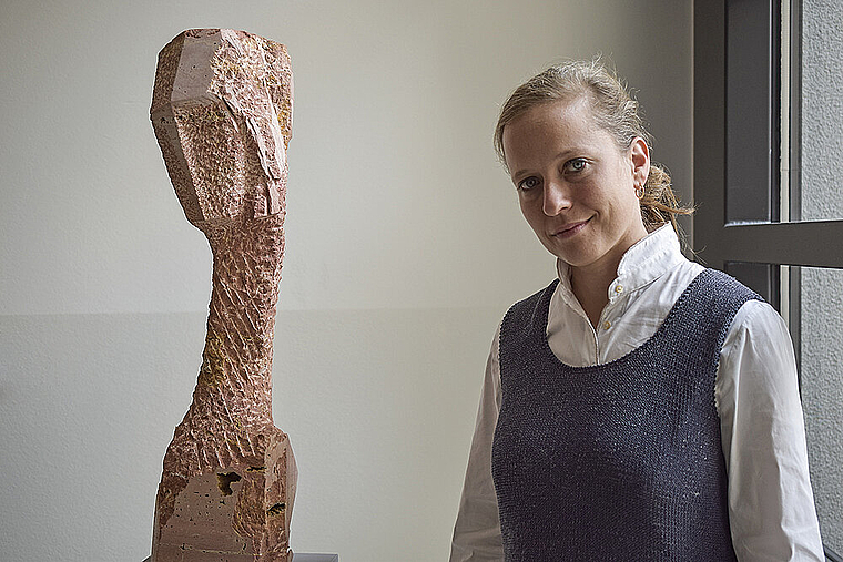 Kopf geneigt: Barbara Schnetzler mit einer ihrer Skulpturen ohne Titel, in persischem Travertin, von 2016. Foto: Bea Asper