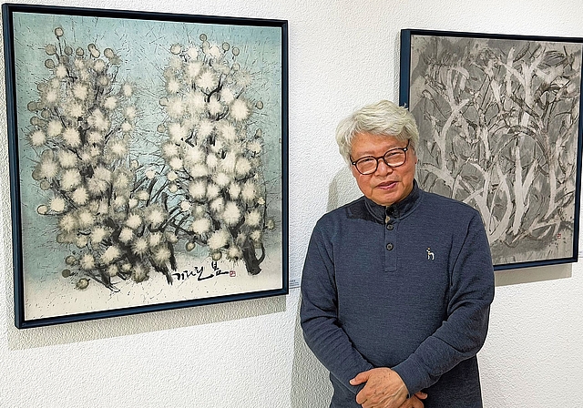 Tuschmalerei auf speziellem Papier: Stephan Ha Sam-du zwischen seinen Werken «Frühlingserwartung» (links) und «Blick ins Dickicht» (rechts). Foto: Christian Fink