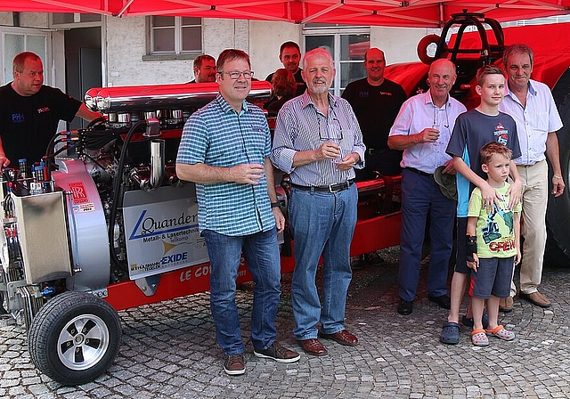 Ein 2,5 Tonnen schwerer Traktor mit 4000 PS: Geschäftsleiter der Furka Reibbeläge AG Marcel Aerni (Mitte vorne) mit Mitarbeitern und dem Tractor-Pulling-Team vor und hinter dem Prototyp. Foto: Gaby Walther 