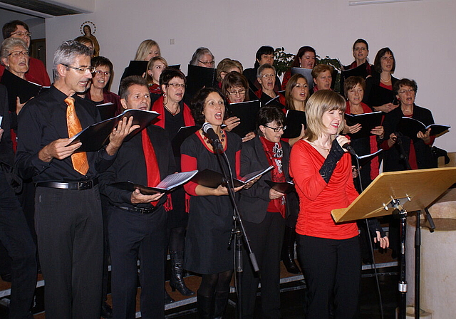 Ausdrucksstark: Chor Gospelfire mit Solistinnen Kathrin Hänggi (in rot) und Natalia Hofer (hinter Mikrofon). Foto: Jürg Jeanloz