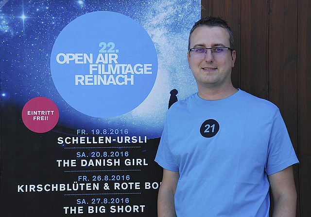 Hofft auf zwei sonnige Wochenenden: Alex Strohm, Präsident des Vereins Filmtage Reinach, vor dem diesjährigen Plakat. Foto: Thomas Brunnschweiler