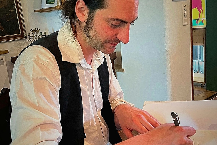 Der «Schloss-Schryber» beim Signieren seines Buches an der Vernissage vom Sonntag: Das Buch von Nico Piazzalonga behandelt die Geschichte des Schlosses Neu-Thierstein in Büsserach. Foto: zvg
