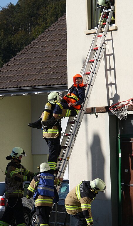 Rettung: Vorsichtig wird die Person über die Leiter aus dem Haus transportiert.
